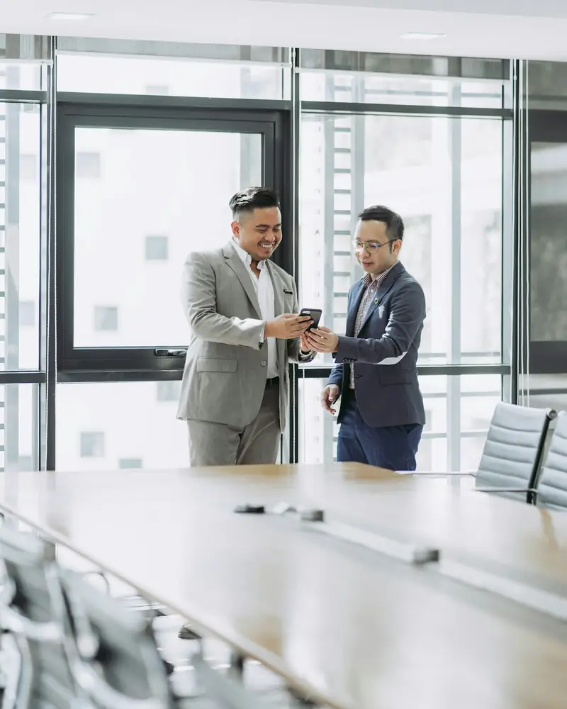 Two business professionals reviewing details together in an office